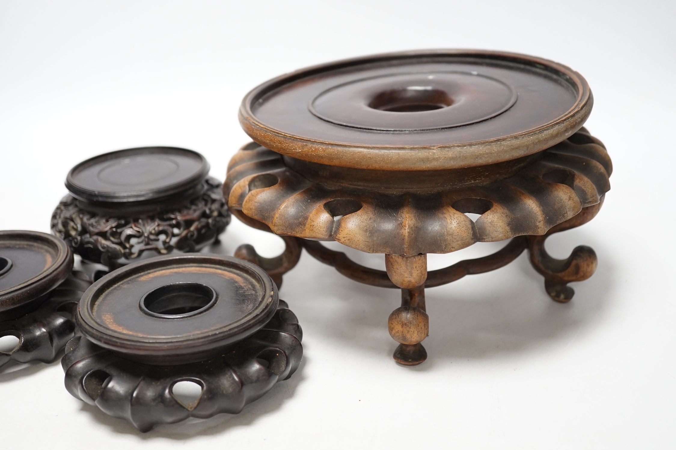 Four Chinese 19th/early 20th century rosewood stands, tallest 10.5cm high